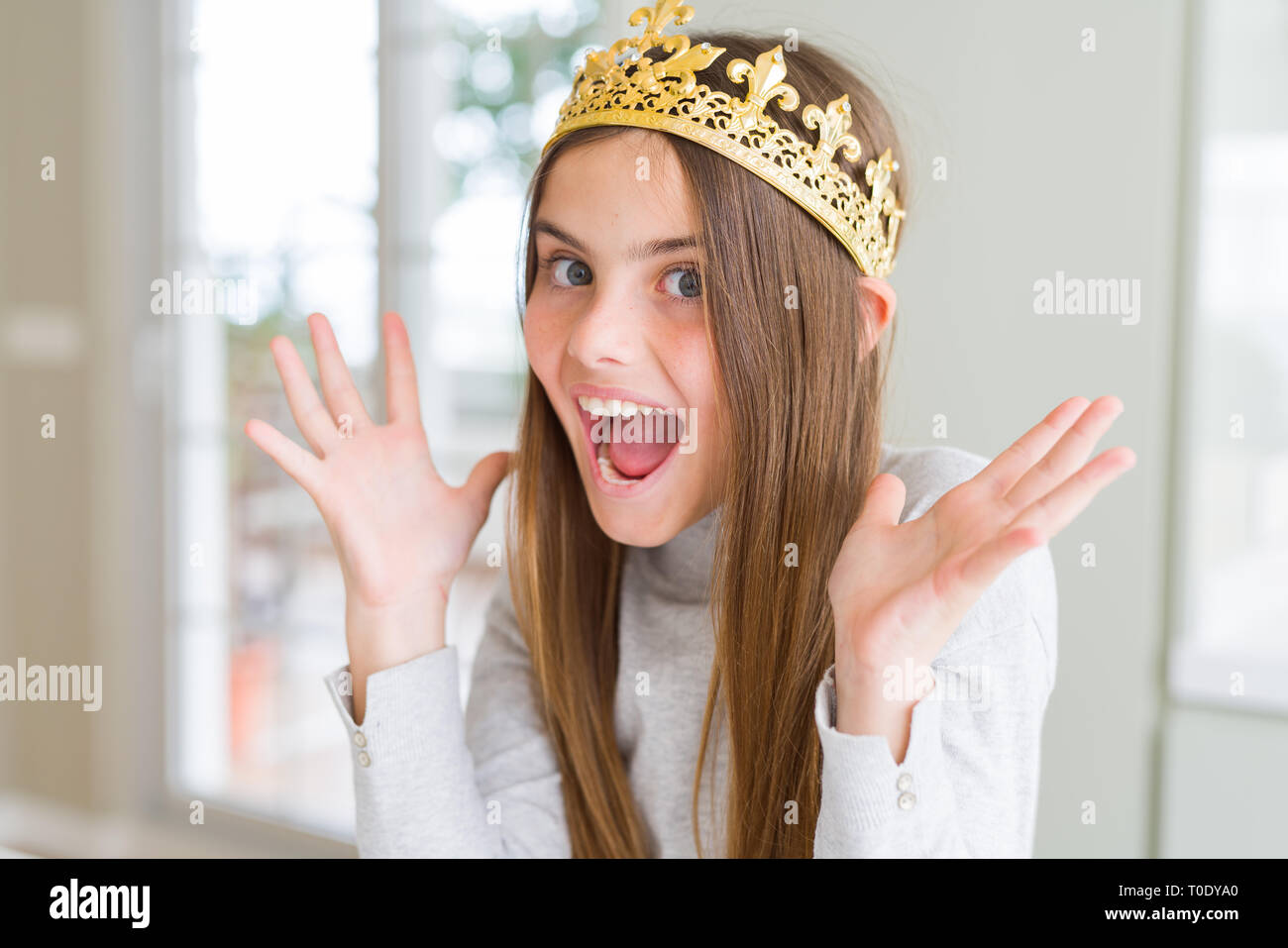 Beautiful young girl wearing a golden crown as a princess from ...