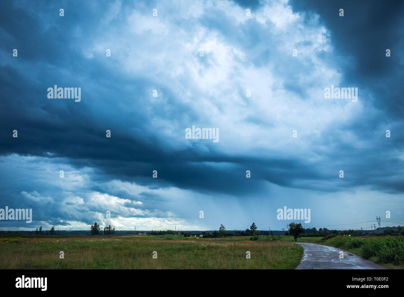 Image of dark Storm clouds in the field Stock Photo - Alamy