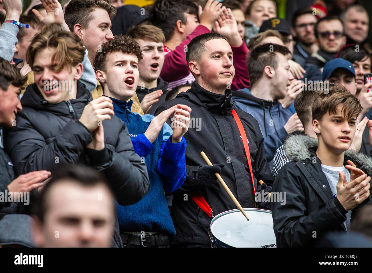 English football club and supporters watching match and playing drum Stock Photo -