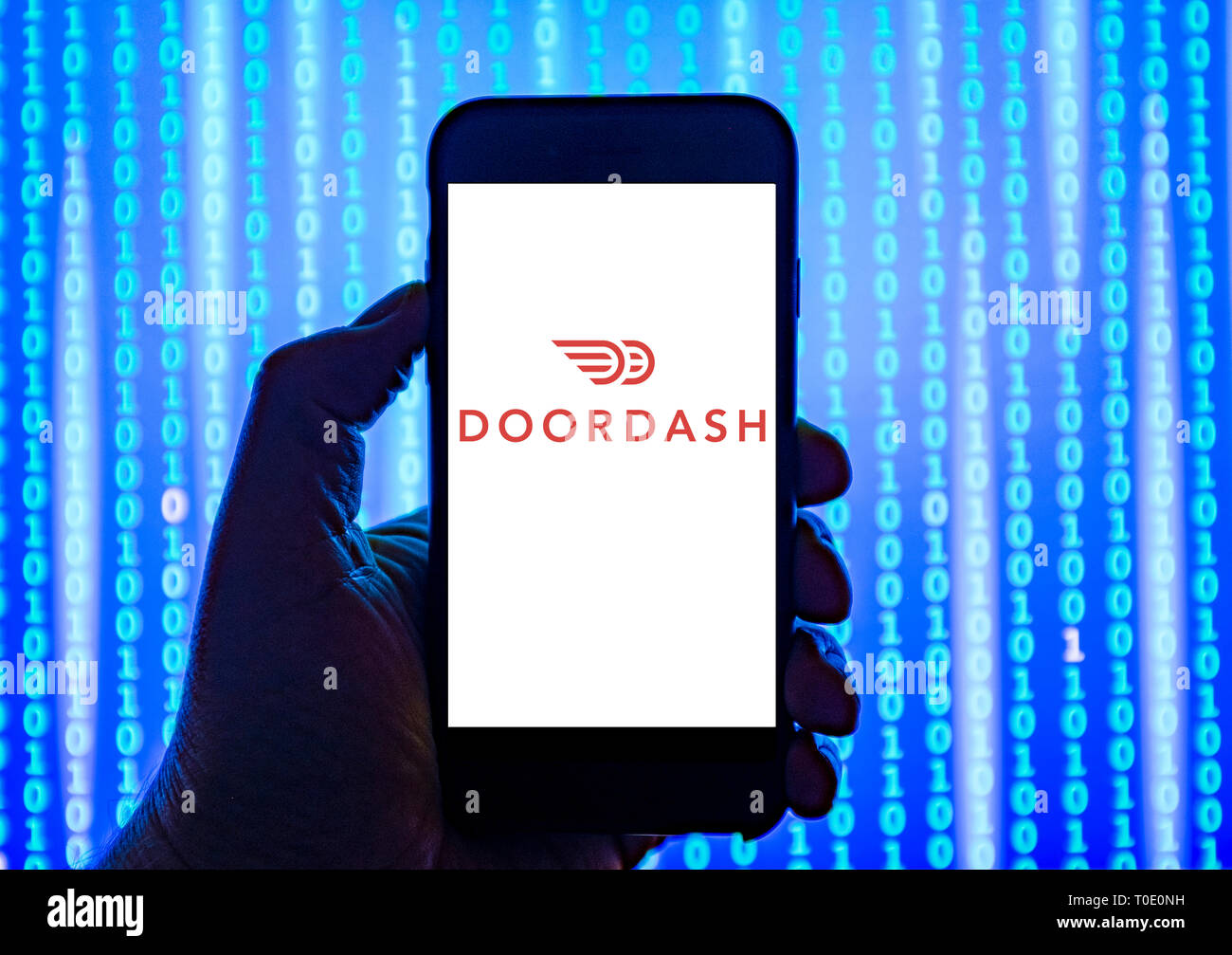 Person Holding Smart Phone With Doordash Food Delivery Logo