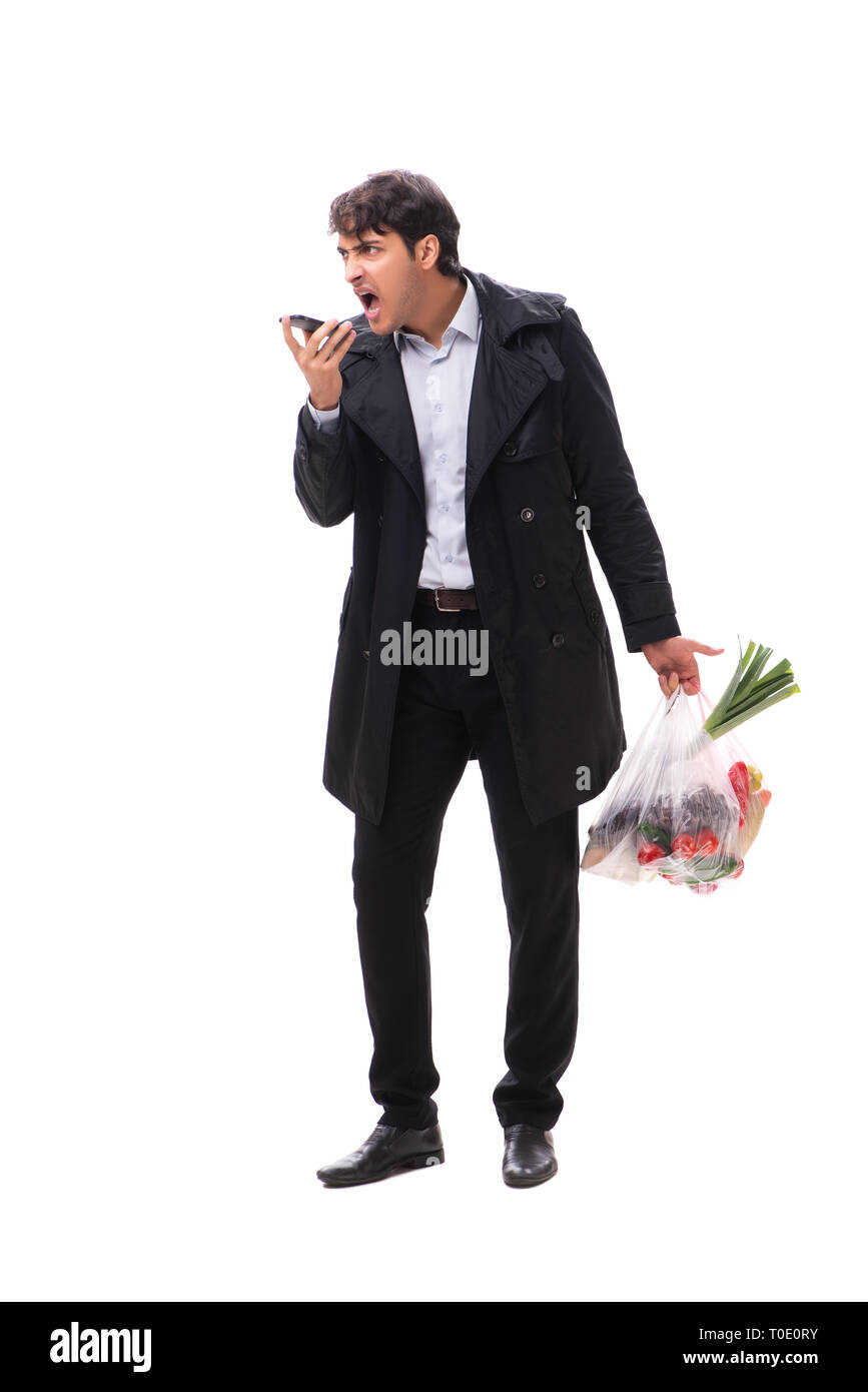 Young handsome man with vegatables in shopping concept Stock Photo