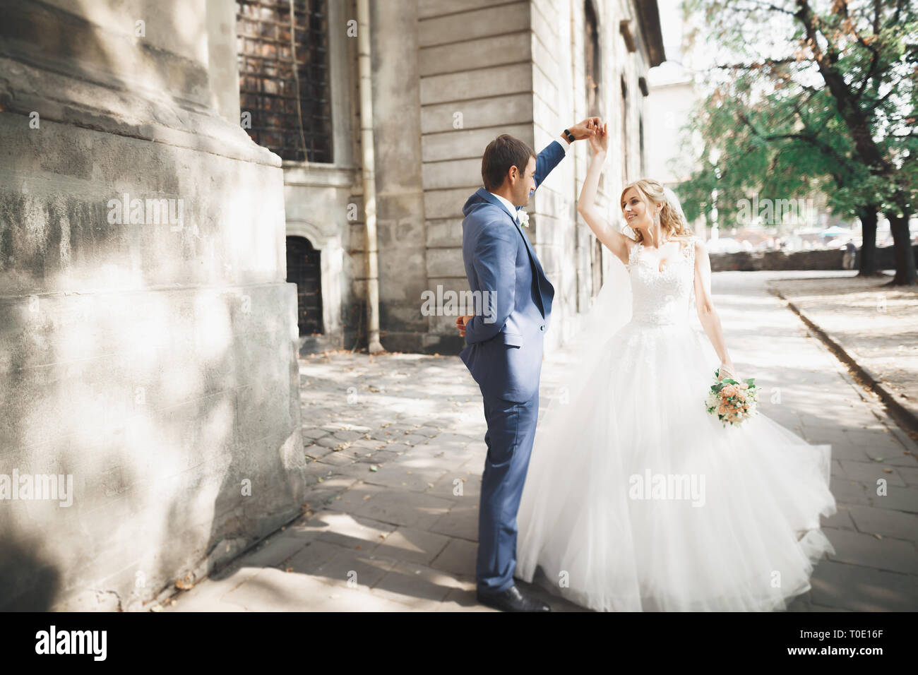 Beautiful caucasian wedding couple just married and dancing their first ...