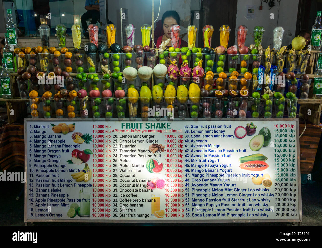 Woman stall holder at fruit shake drinks stall at street food night market, Luang Prabang, Laos, SE Asia Stock Photo