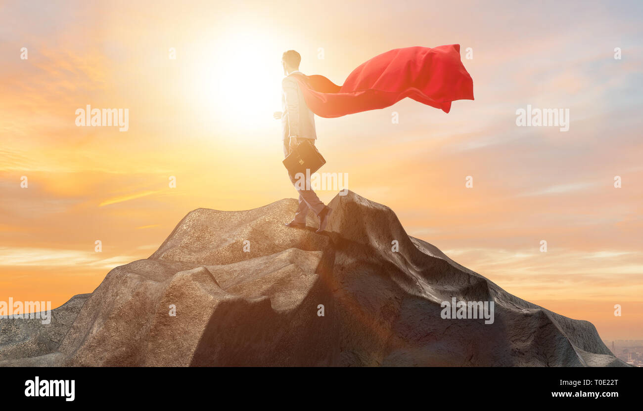 Superhero businessman on top of mountain Stock Photo - Alamy
