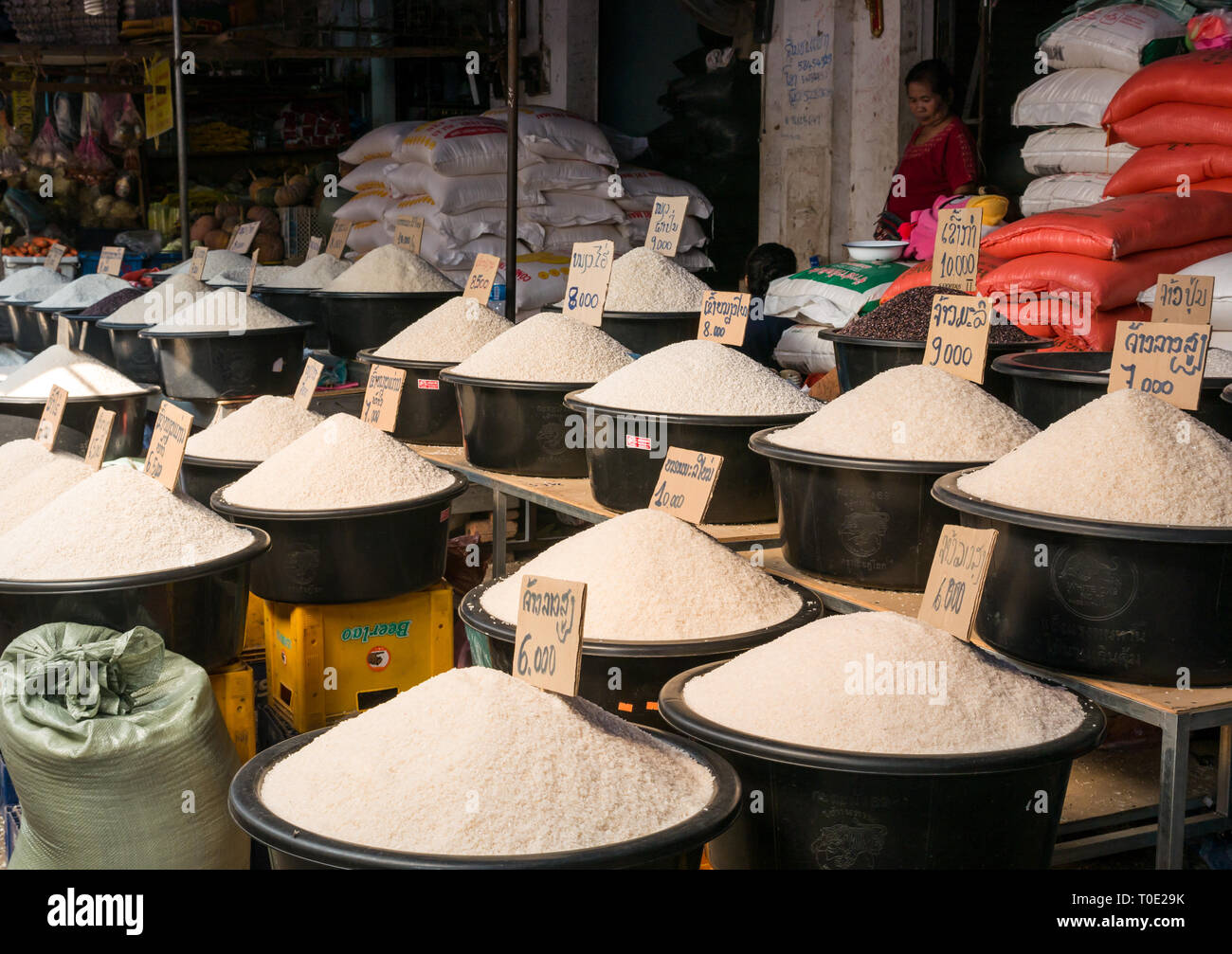 Buckets of rice varieties for sale at market stall, Phosy day market, Luang Prabang, Laos, SE Asia Stock Photo
