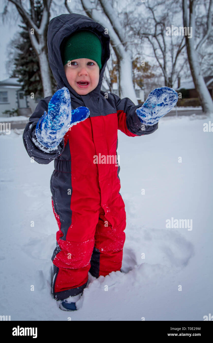 Toddler in snow suit enjoying the first snowy day Stock Photo - Alamy