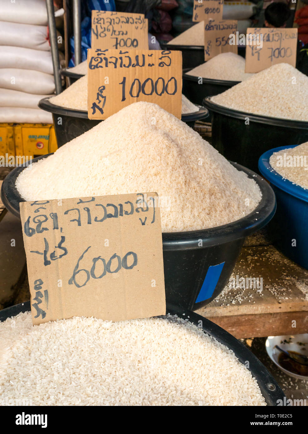 Buckets of rice varieties for sale at market stall, Phosy day market, Luang Prabang, Laos, SE Asia Stock Photo