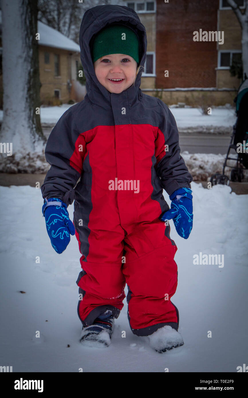 Toddler in snow suit enjoying the first snowy day Stock Photo Alamy