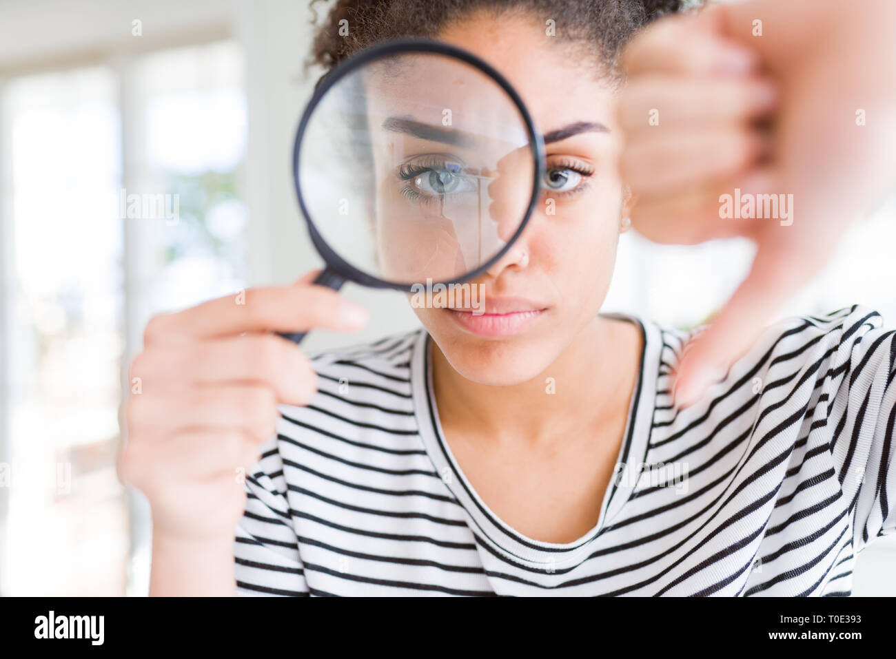 Woman looking at the crotch with a loupe - Stock Photo [76109646