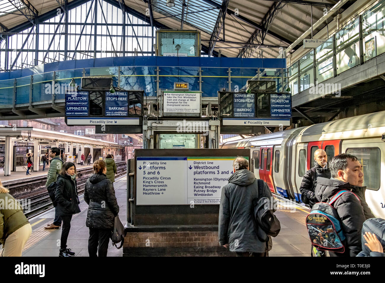 People waiting on the platform  for a District Line train at  Earls Court Underground Station , London, UK Stock Photo