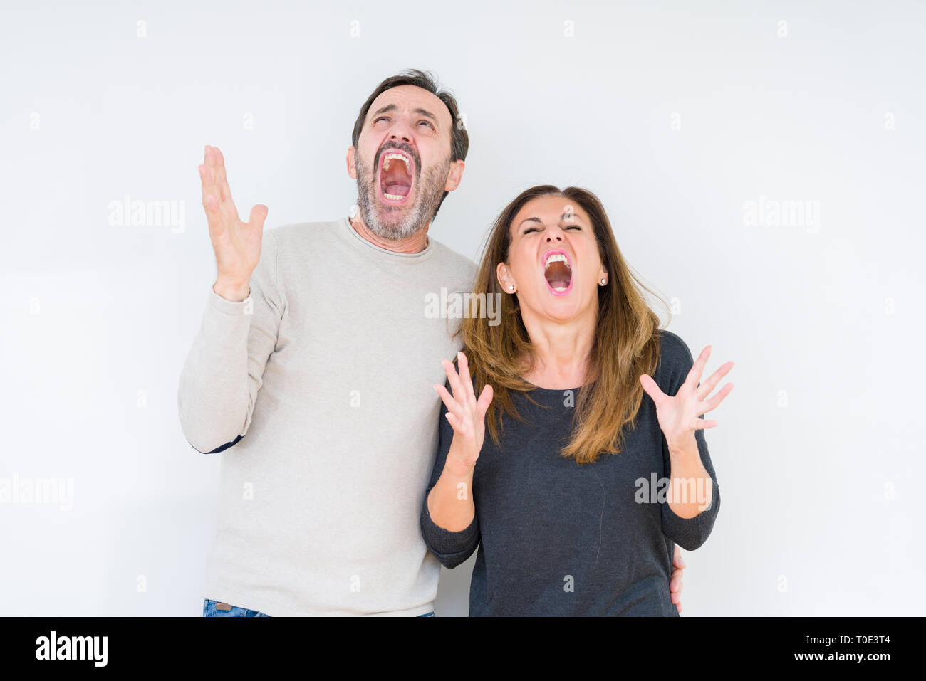 Beautiful middle age couple in love over isolated background crazy and ...