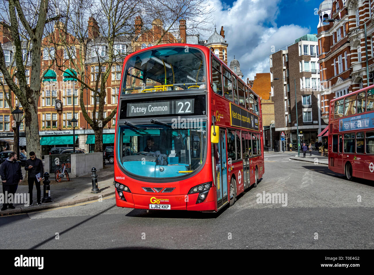 A number 22 double decker red London Bus making it's way around Sloane Square on it's way to Putney Common, London, UK Stock Photo