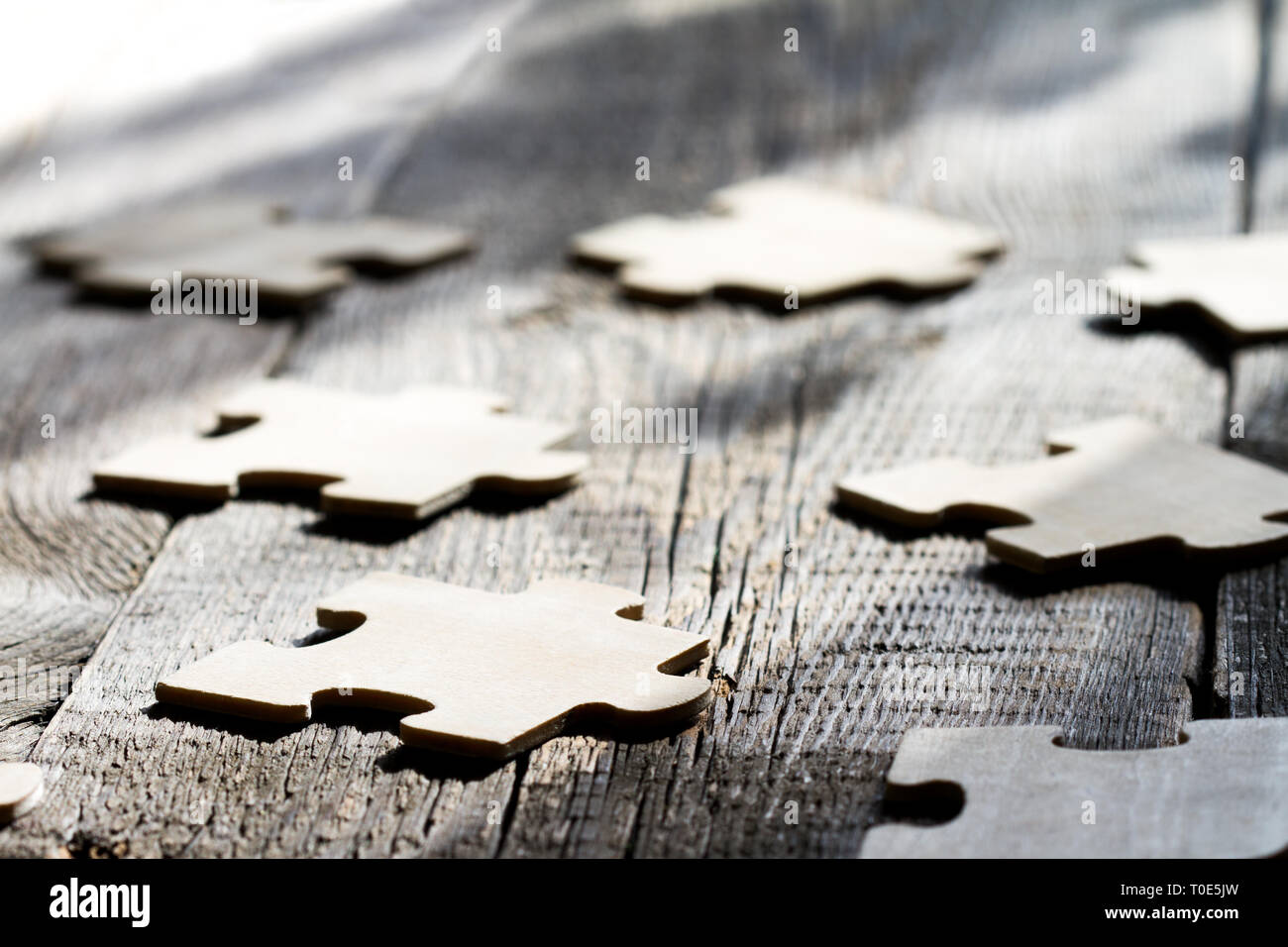 Teamwork in business abstract concept with puzzle on wooden board Stock Photo