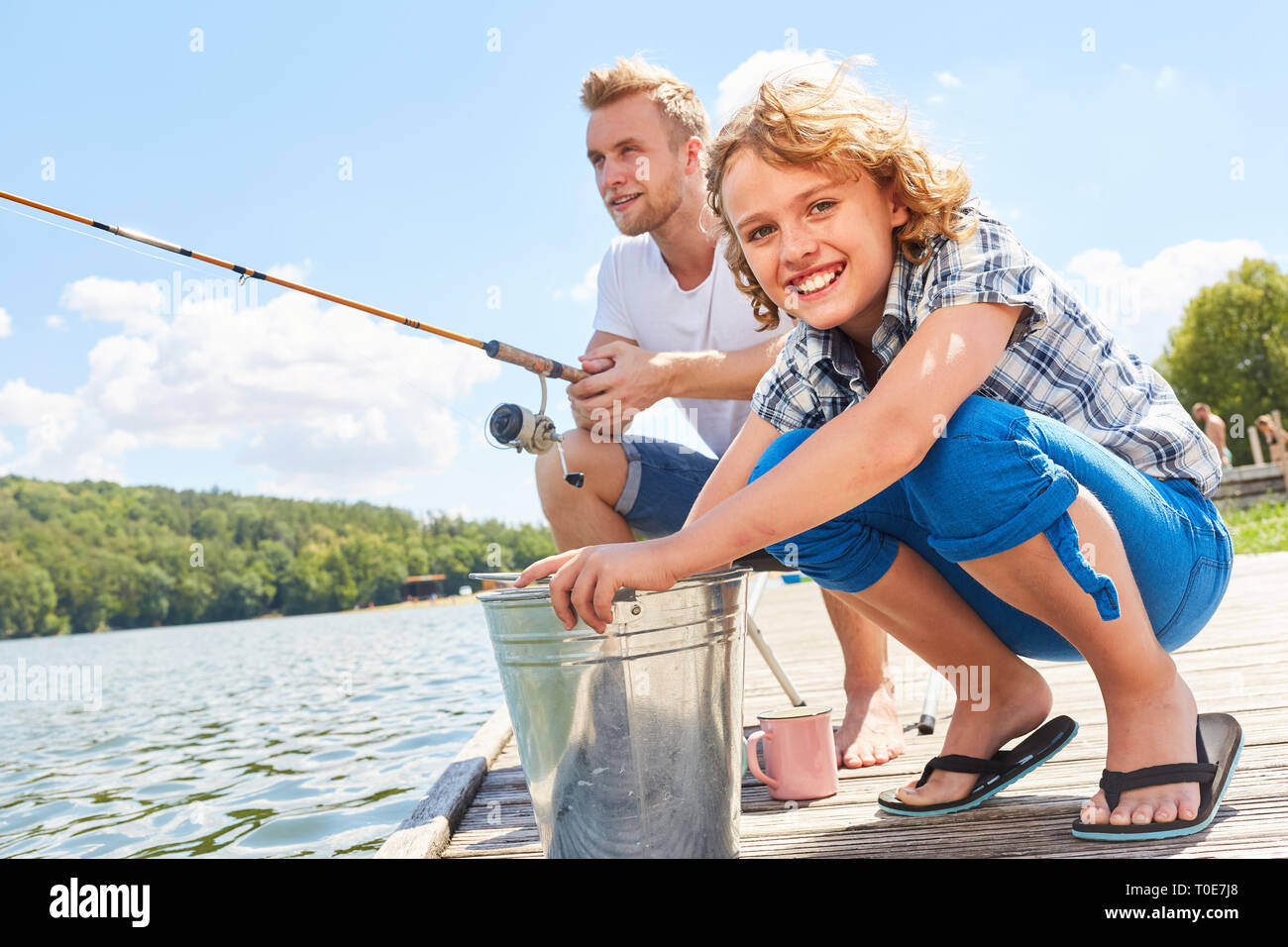 Father and son fishing on the weekend at the lake as a hobby and relaxation Stock Photo