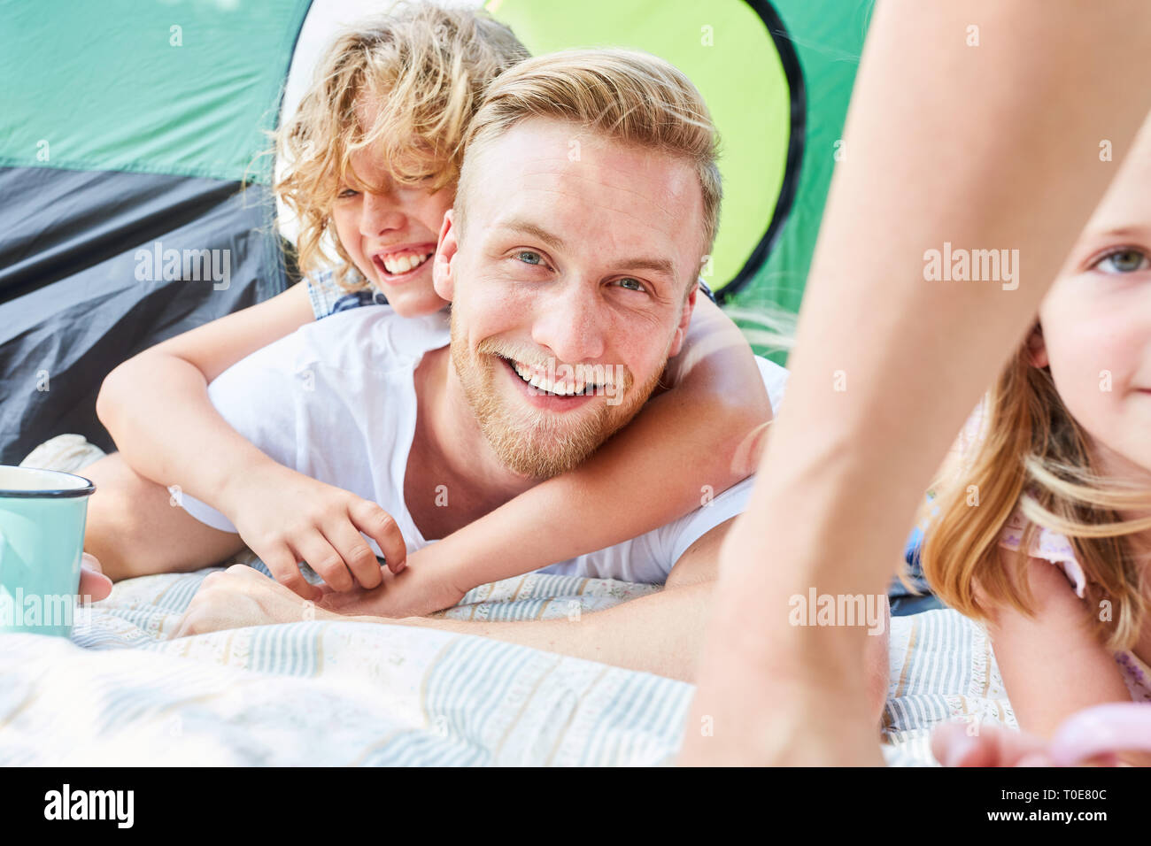 Father and son together in front of the tent on camping holiday in de summer holidays Stock Photo