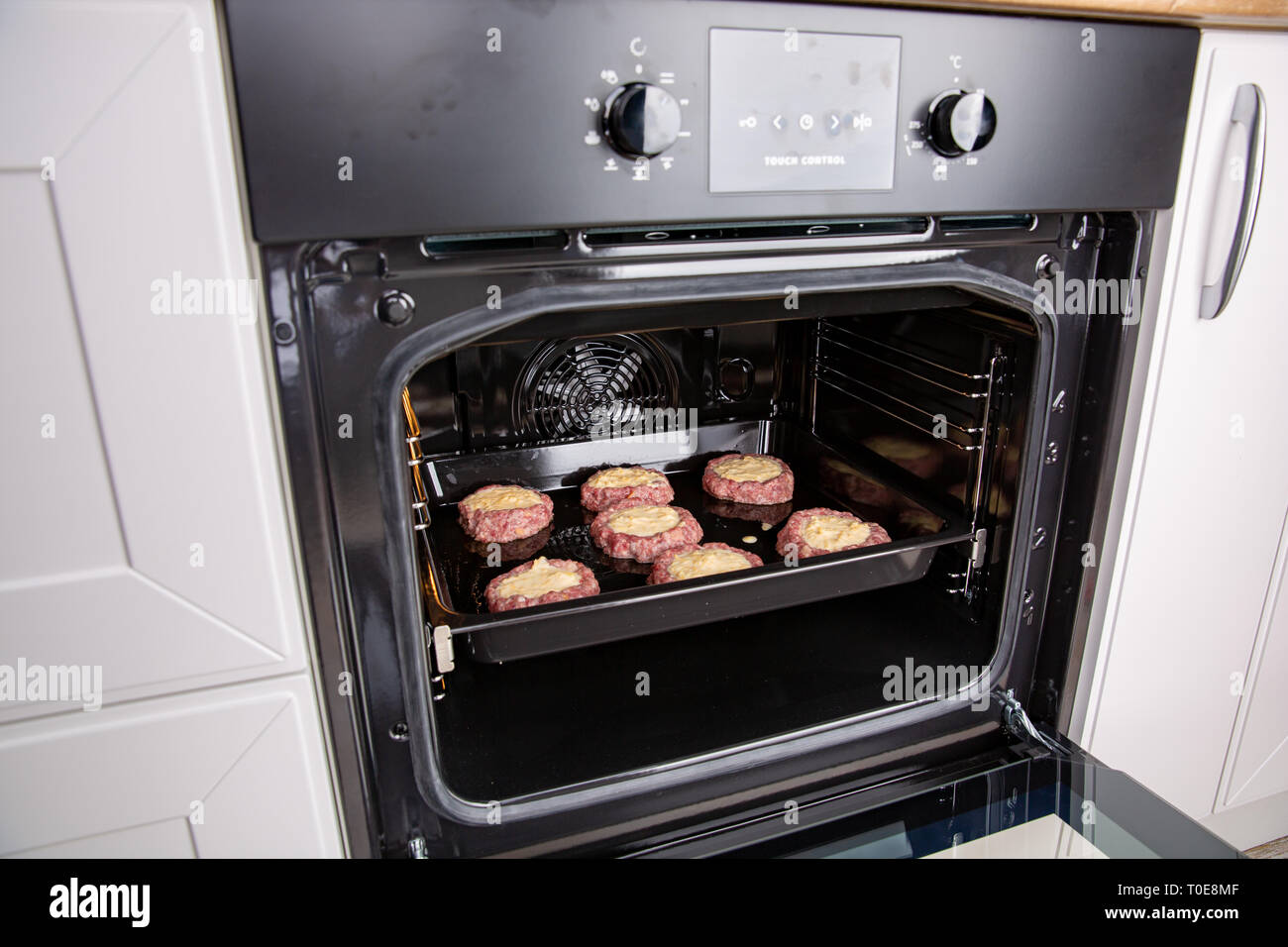 Fresh hot veal cutlet in fillo dough in the open oven. Process of home