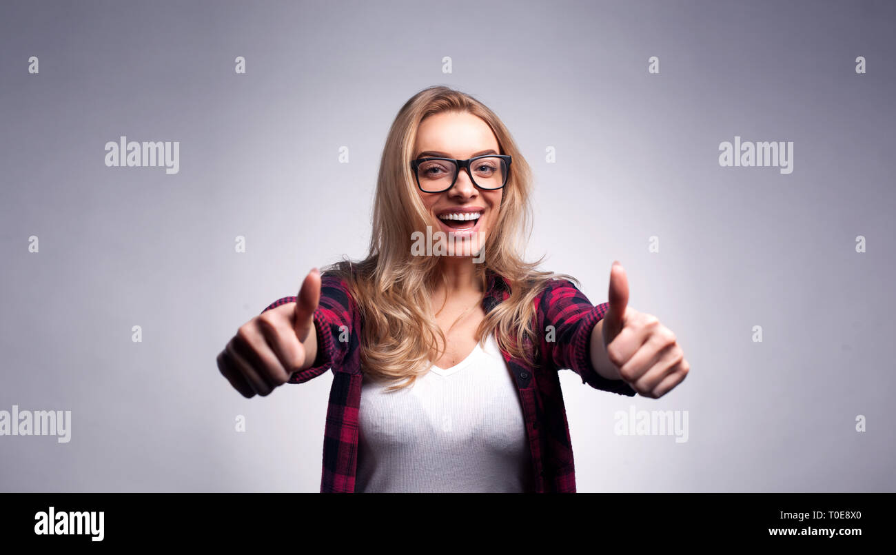 Beautiful woman portrait showing thumbs up Stock Photo - Alamy