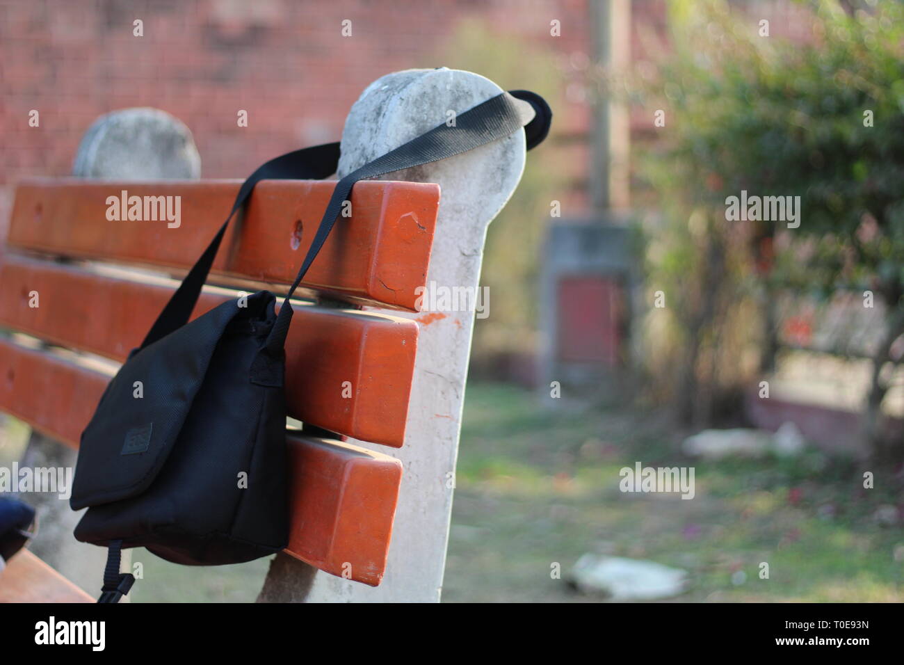 canon camera bag hanging on chair Stock Photo