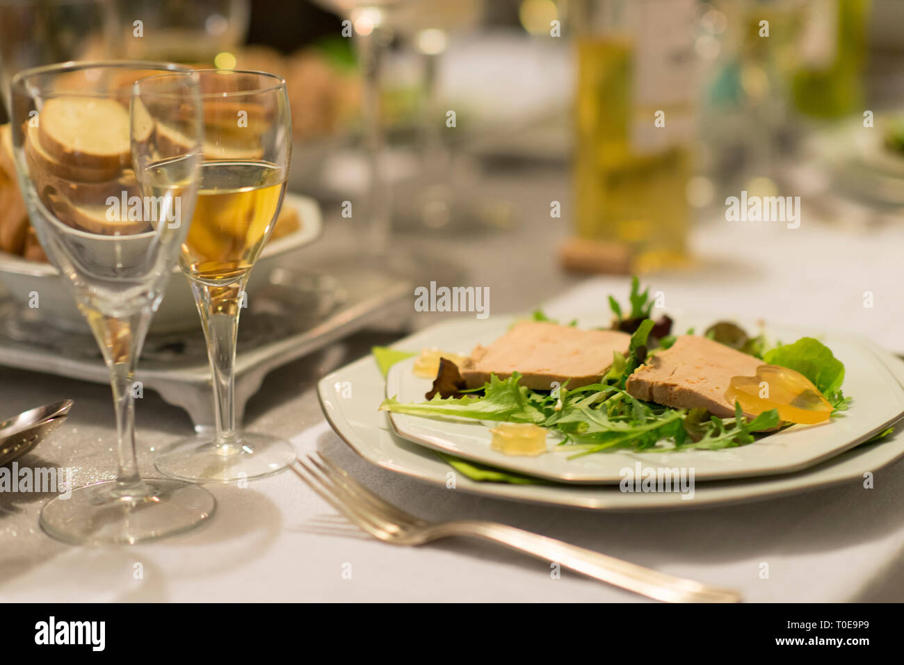 Foie gras on salad and sweet white wine for christmas diner is a french speciality for festive Christmas celebration Stock Photo