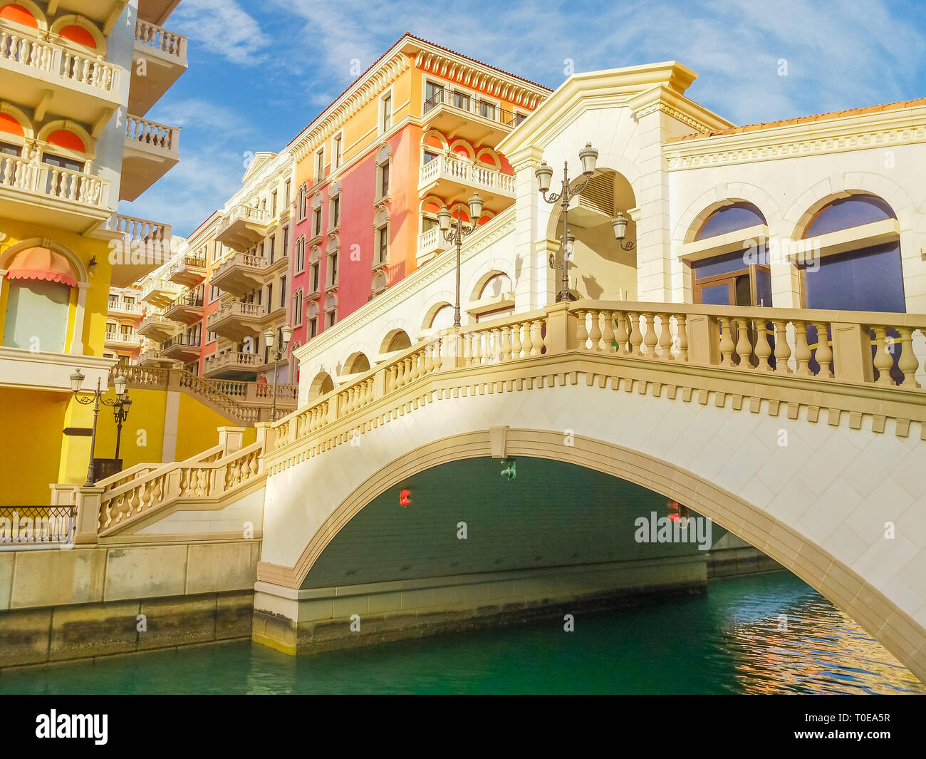 Venetian bridge on canals of picturesque district of Doha, Qatar. Venice at Qanat Quartier in the Pearl-Qatar, Persian Gulf, Middle East. Famous Stock Photo