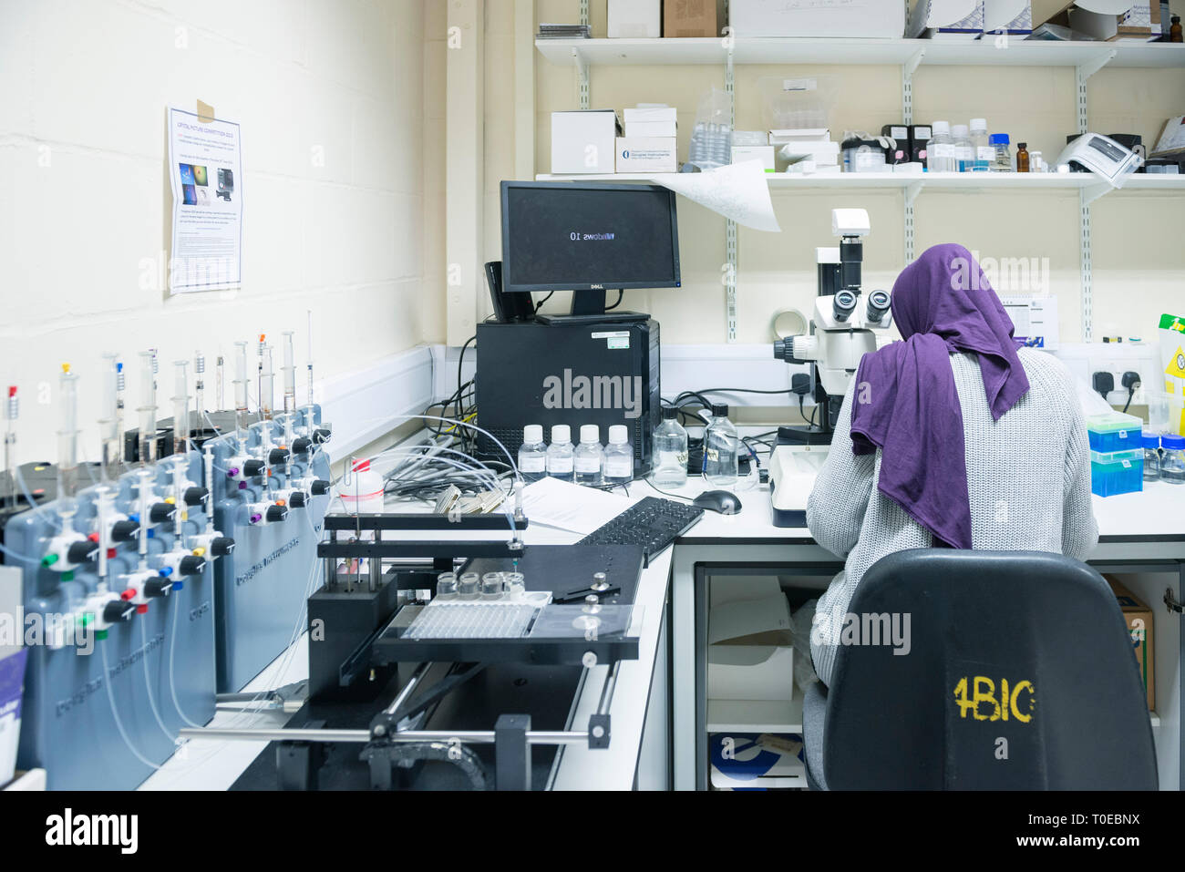 Islamic Lab Names A muslim woman uses the scientific equipment in a research laboratory ...