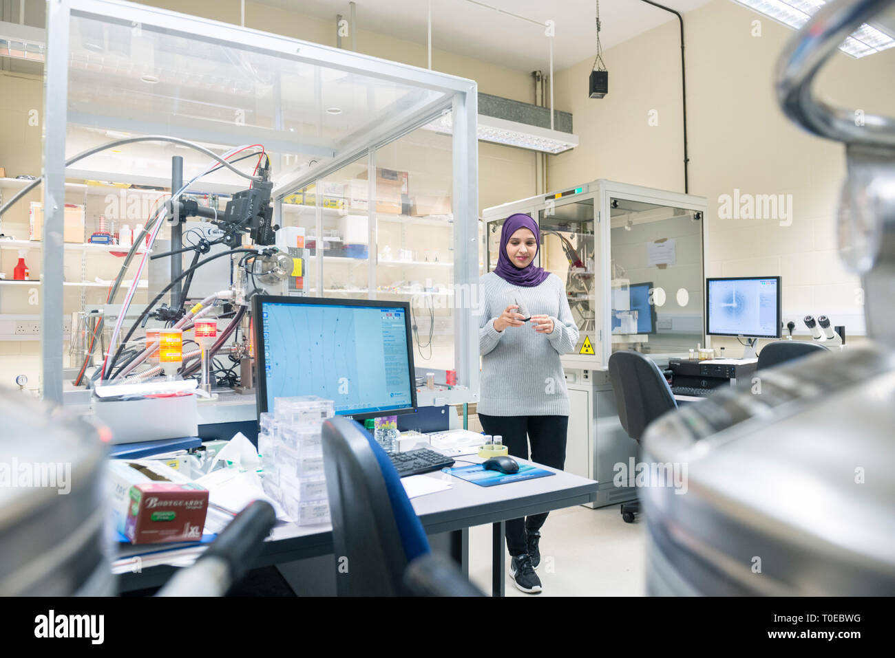 A muslim woman uses the scientific equipment in a research laboratory ...
