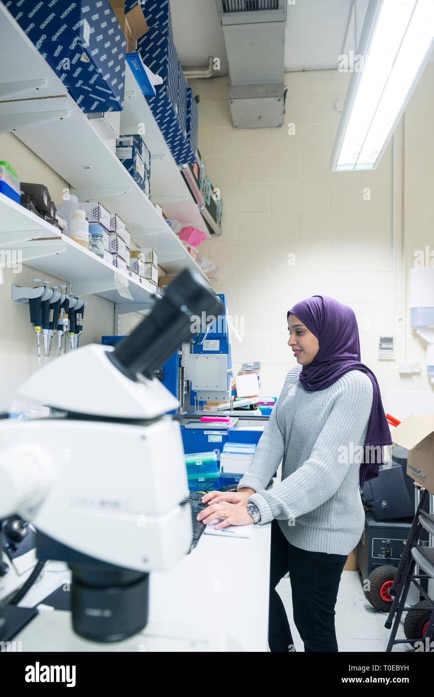 A muslim woman uses the scientific equipment in a research laboratory ...