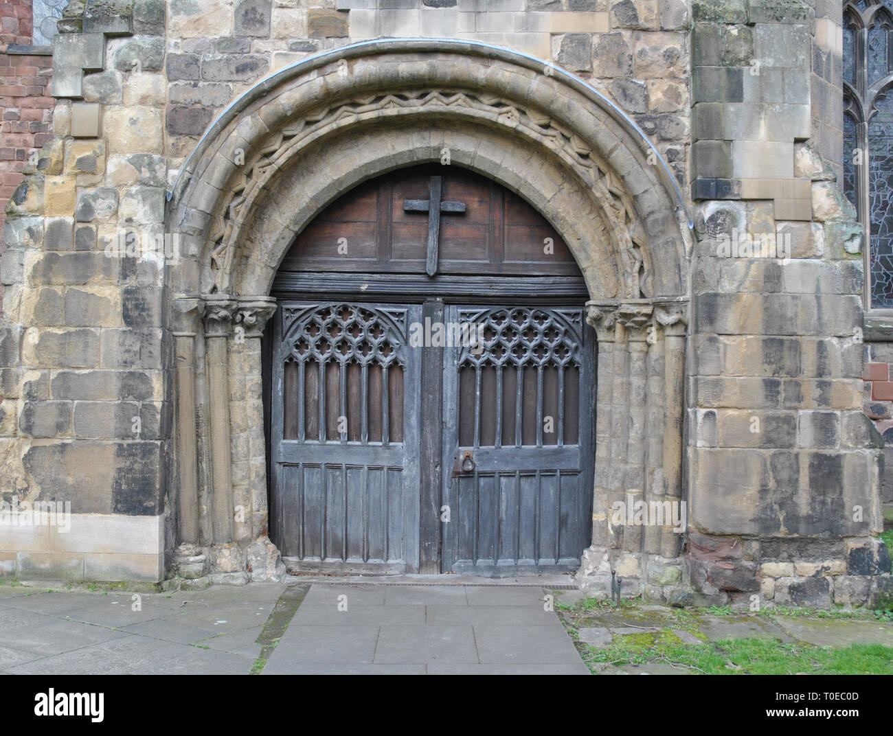 An arched doorway in an old English church Stock Photo