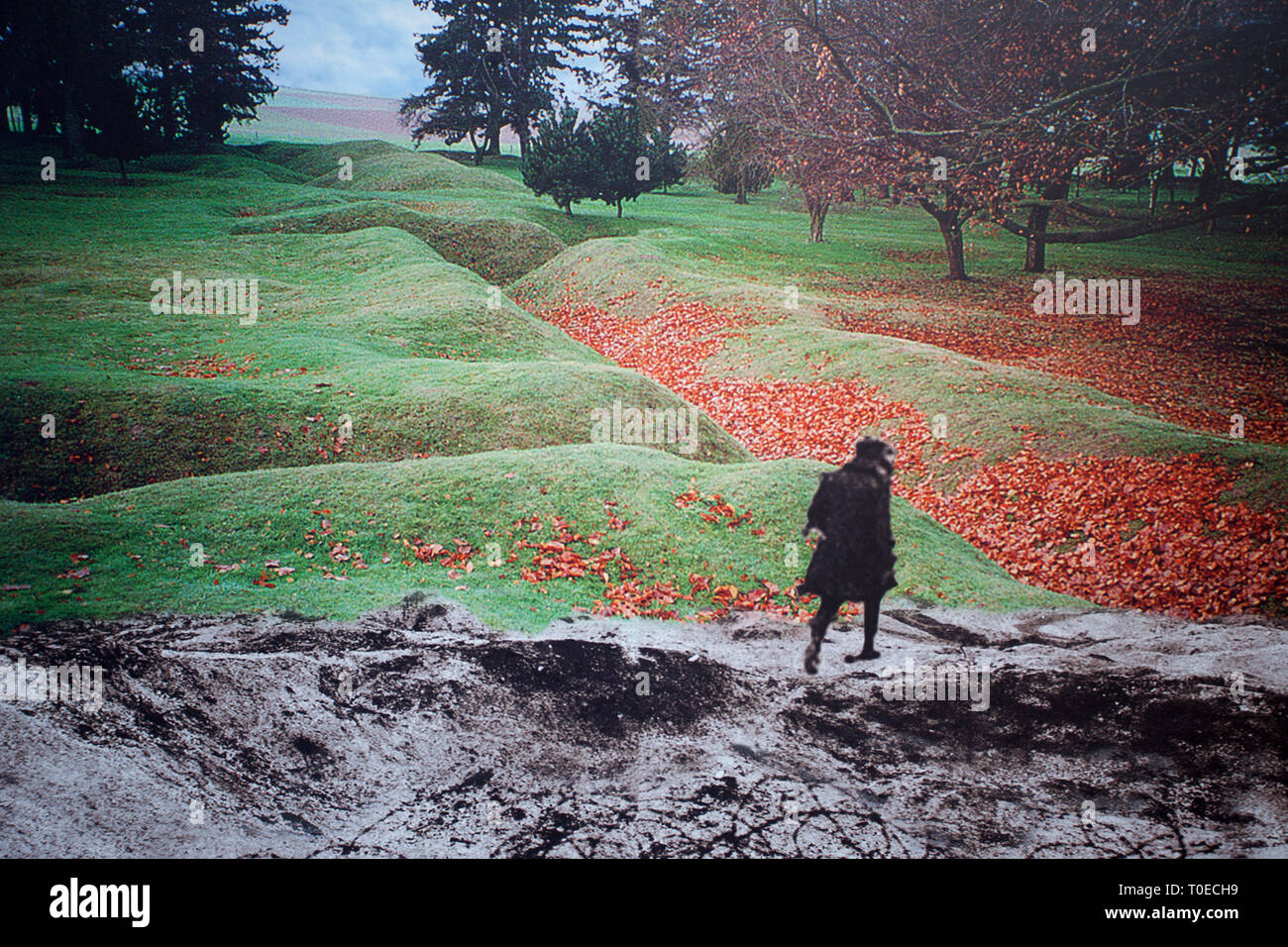 Composite image of a soldier crossing the battlefield combined with a modern day scene of the trenches from world war 1 Stock Photo