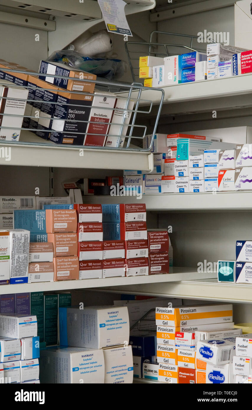 Various medications and drugs on chemist shelves in a pharmacy. Stock Photo