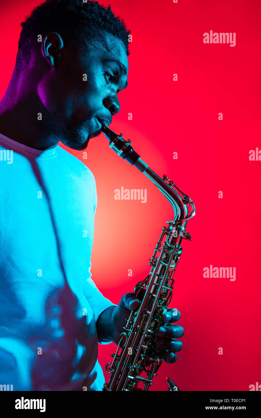 African American handsome jazz musician playing the saxophone in the