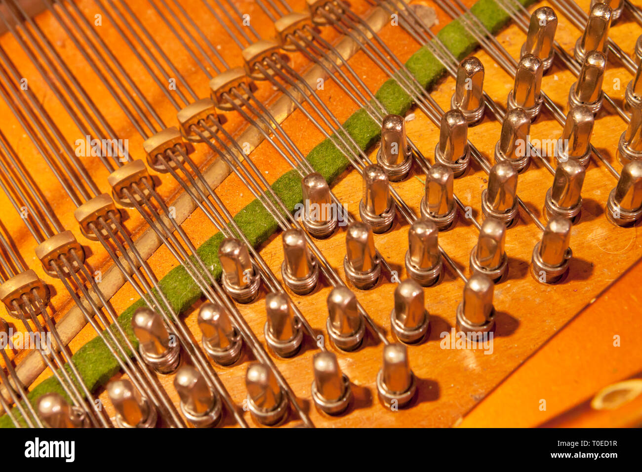 A grand piano with cover raised revealing piano interior. Stock Photo