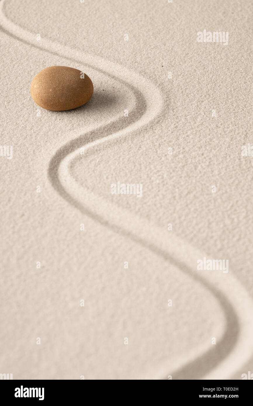 Minimalism zen sand and stone composition. Concept for meditation relaxation and concentration. Spiritual minimal background with copy space. Stock Photo