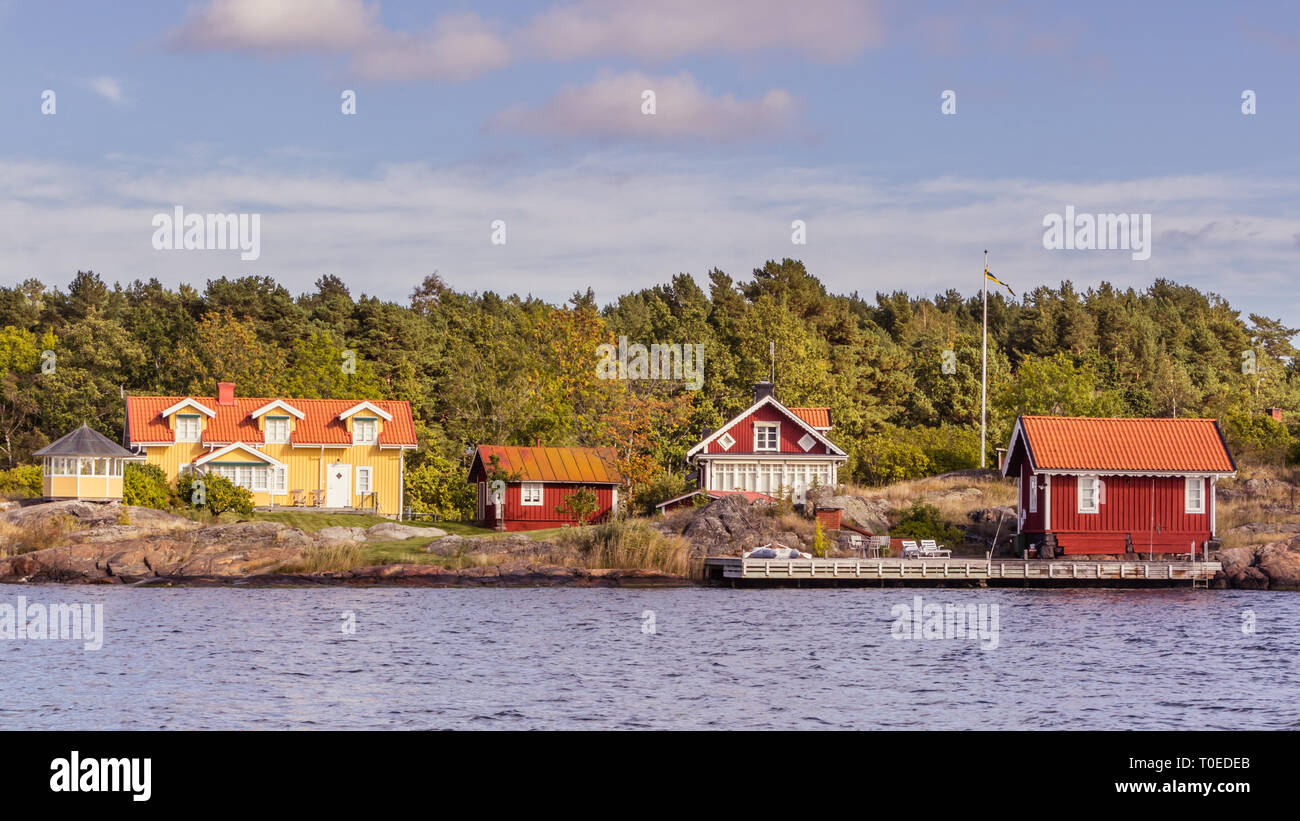 Red And Yellow Cottages On The Coast Of South Sweden Stock Photo