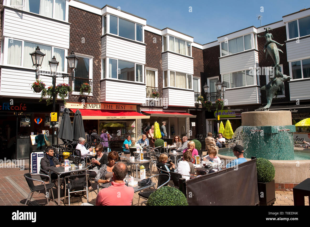 People sitting outside coffee shop in the seaside town of Brighton, Sussex, England. Stock Photo