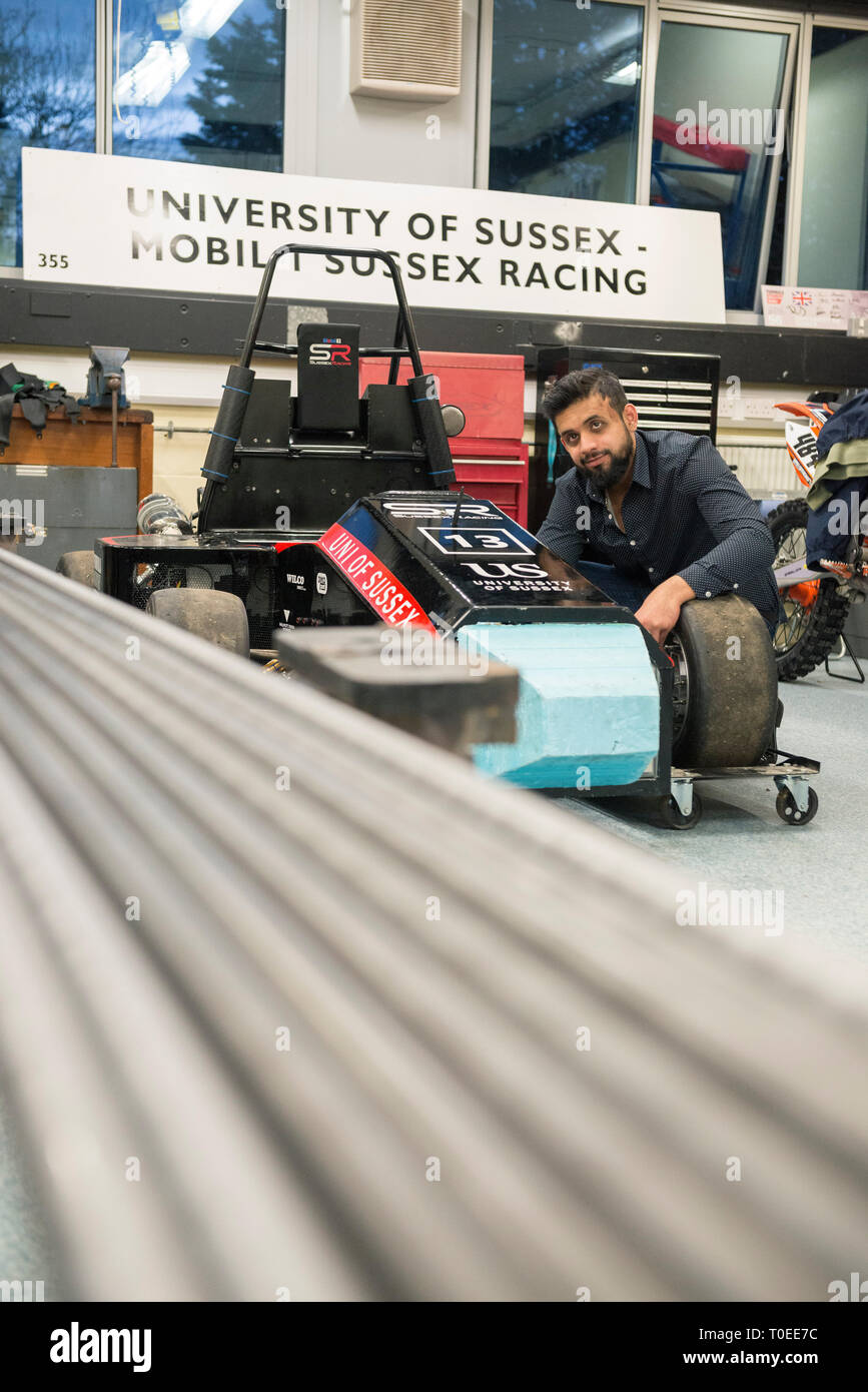 A young international muslim student woking on a racing motorsport cart in the mechanical engineering department of the University of Sussex Stock Photo