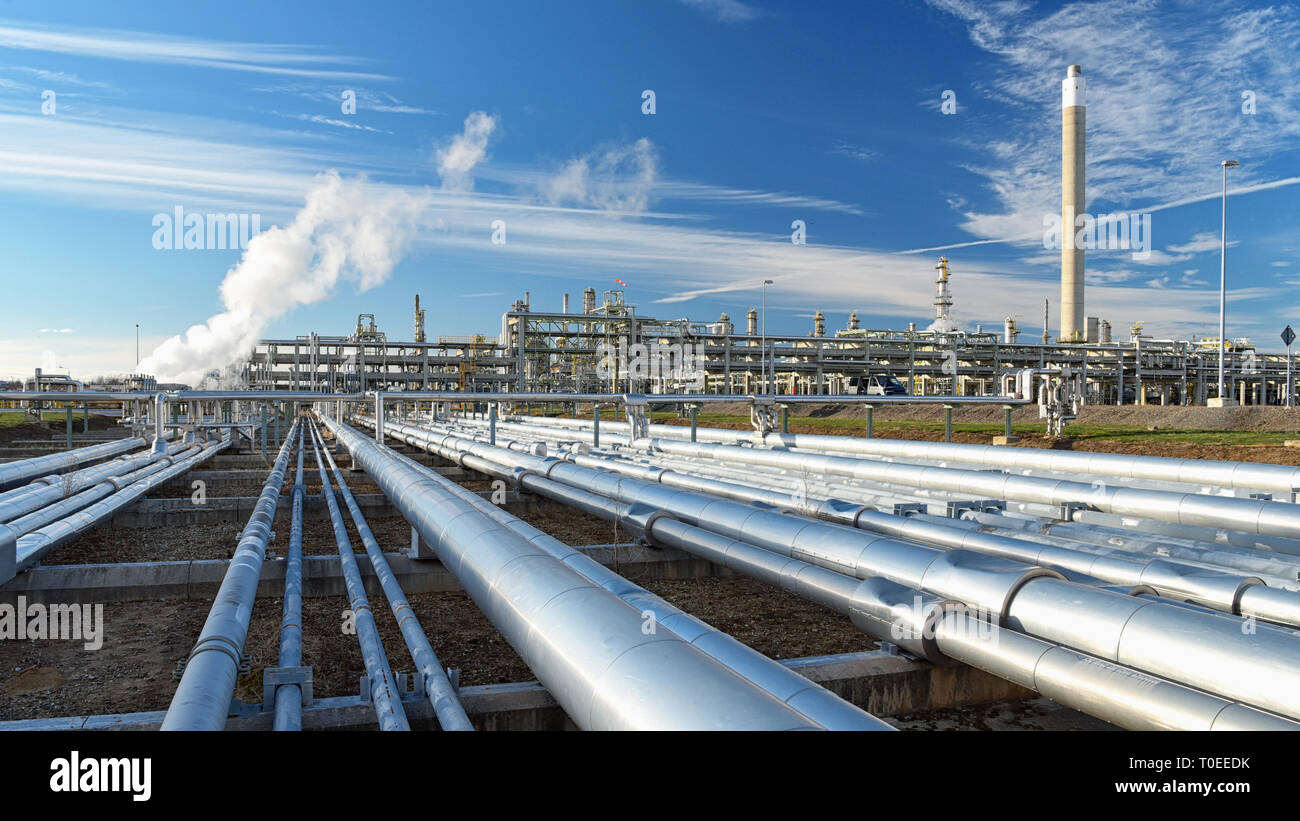 pipelines and buildings of a refinery - industrial plant for fuel production Stock Photo