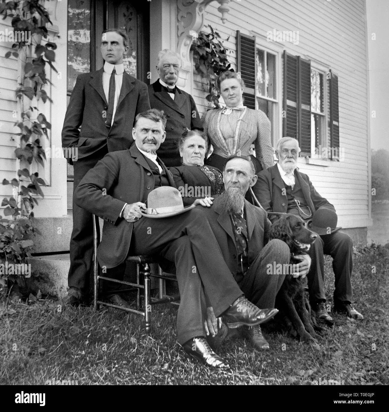 The family elders gather outside of the house for a group portrait, ca. 1915. Stock Photo
