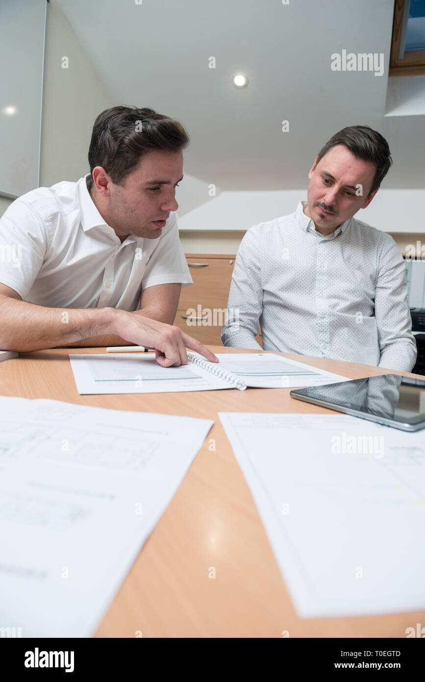 Two men talking in a room hi-res stock photography and images - Alamy