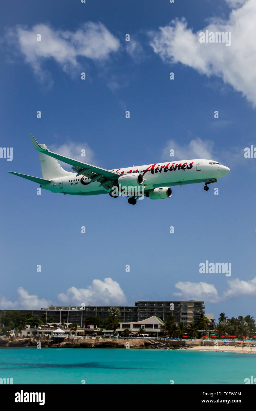 MAHO  BAY BEACH - AUGUST 1:  Aeroplane Caribbean Airlines is landing on Princess Juliana International Airport, over Maho Bay Beach seen in St.Martin/ Stock Photo