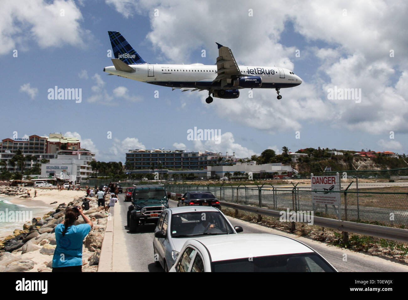 MAHO BAY BEACH, ST MAARTEN -  AUGUST 01, 2015: Airplane Jet Blue is landing on Princess Juliana International Airport, over famous Maho Bay Beach. Stock Photo