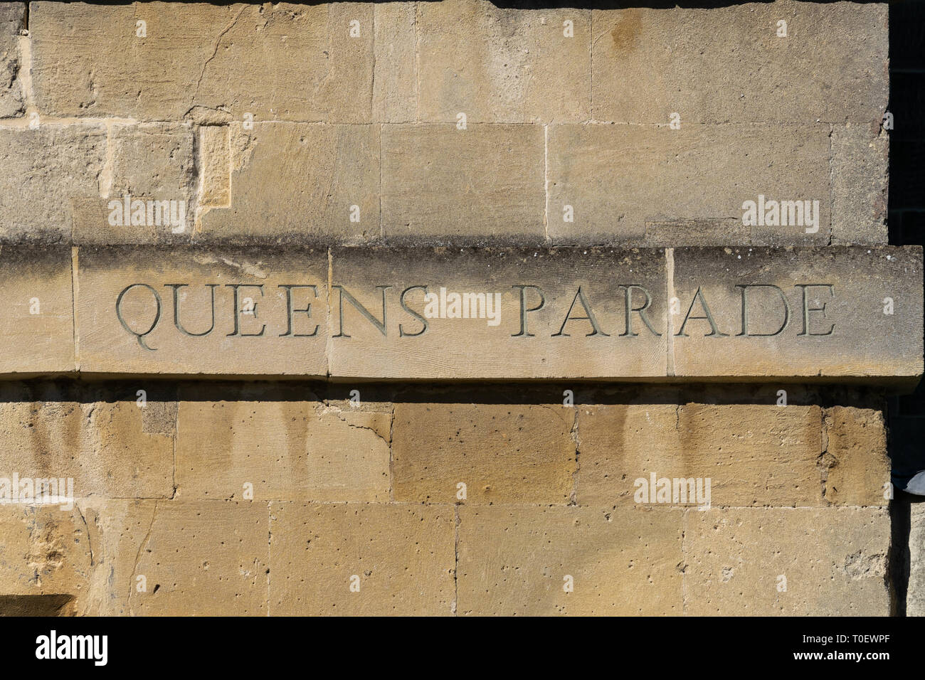 Street name for Queens Parade on the side of a building in Bath