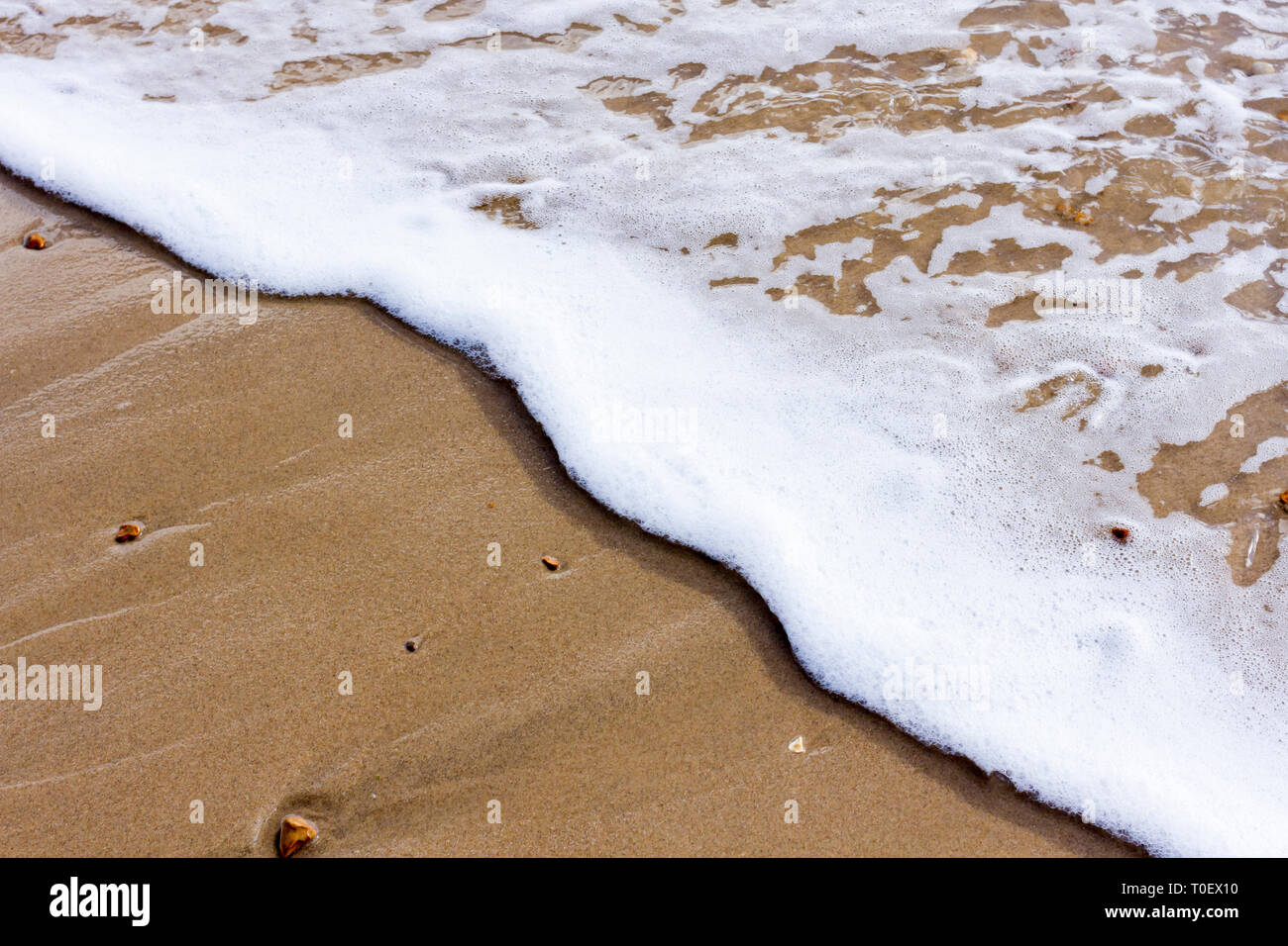 Closeup of some waves lapping onto the beach, Bournemouth, Dorset, UK Stock Photo