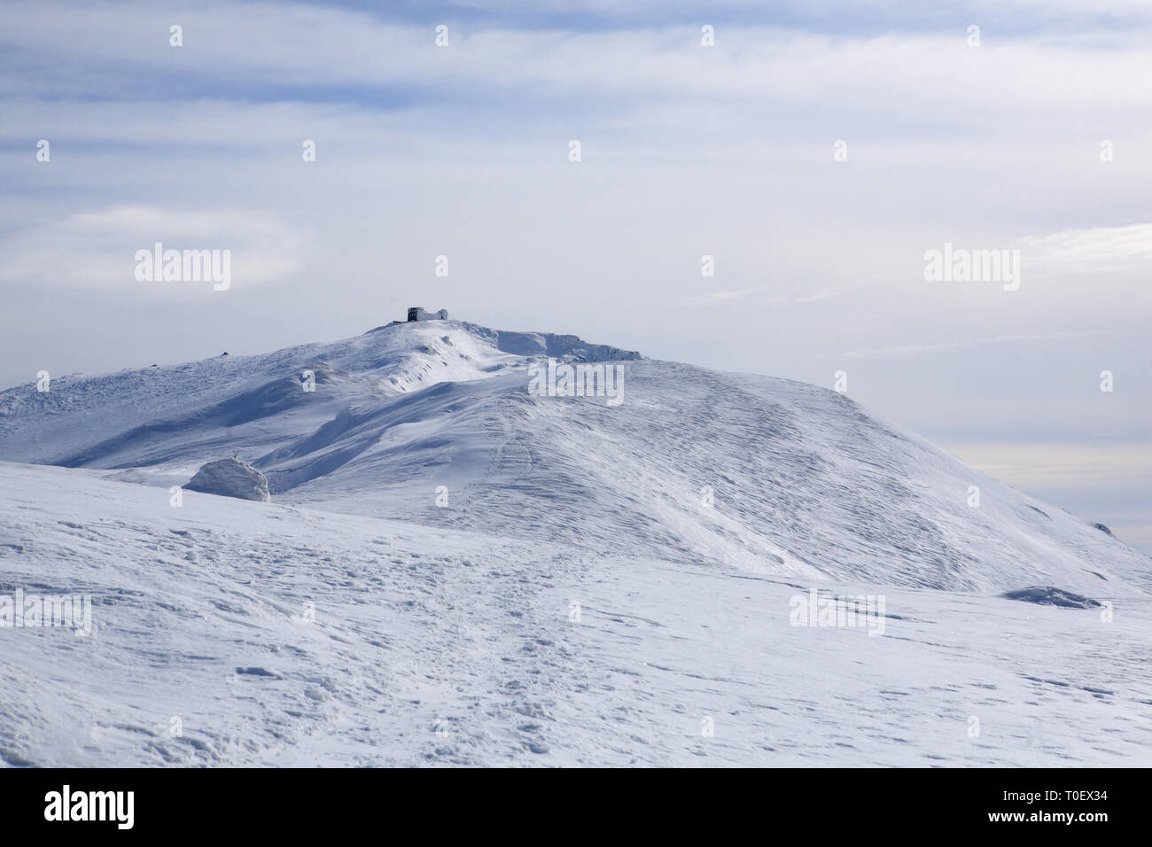 The mountains are covered with snow under a bright blue sky Stock Photo ...