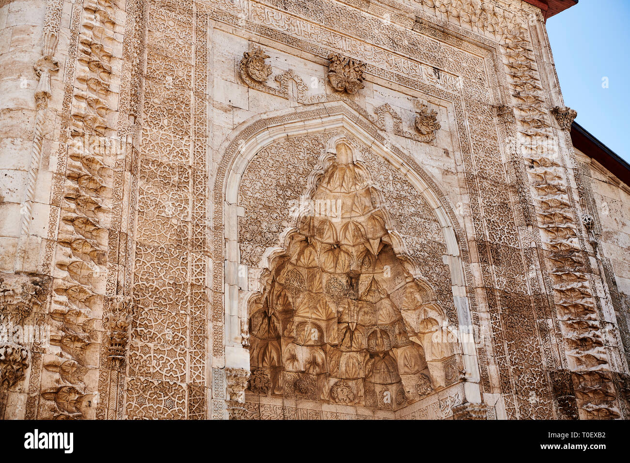 The marble crown gate of Gök Medrese has a very rich decorative appearance. Its islamic Muqarnas corbelled vault is made up of a large number of minia Stock Photo