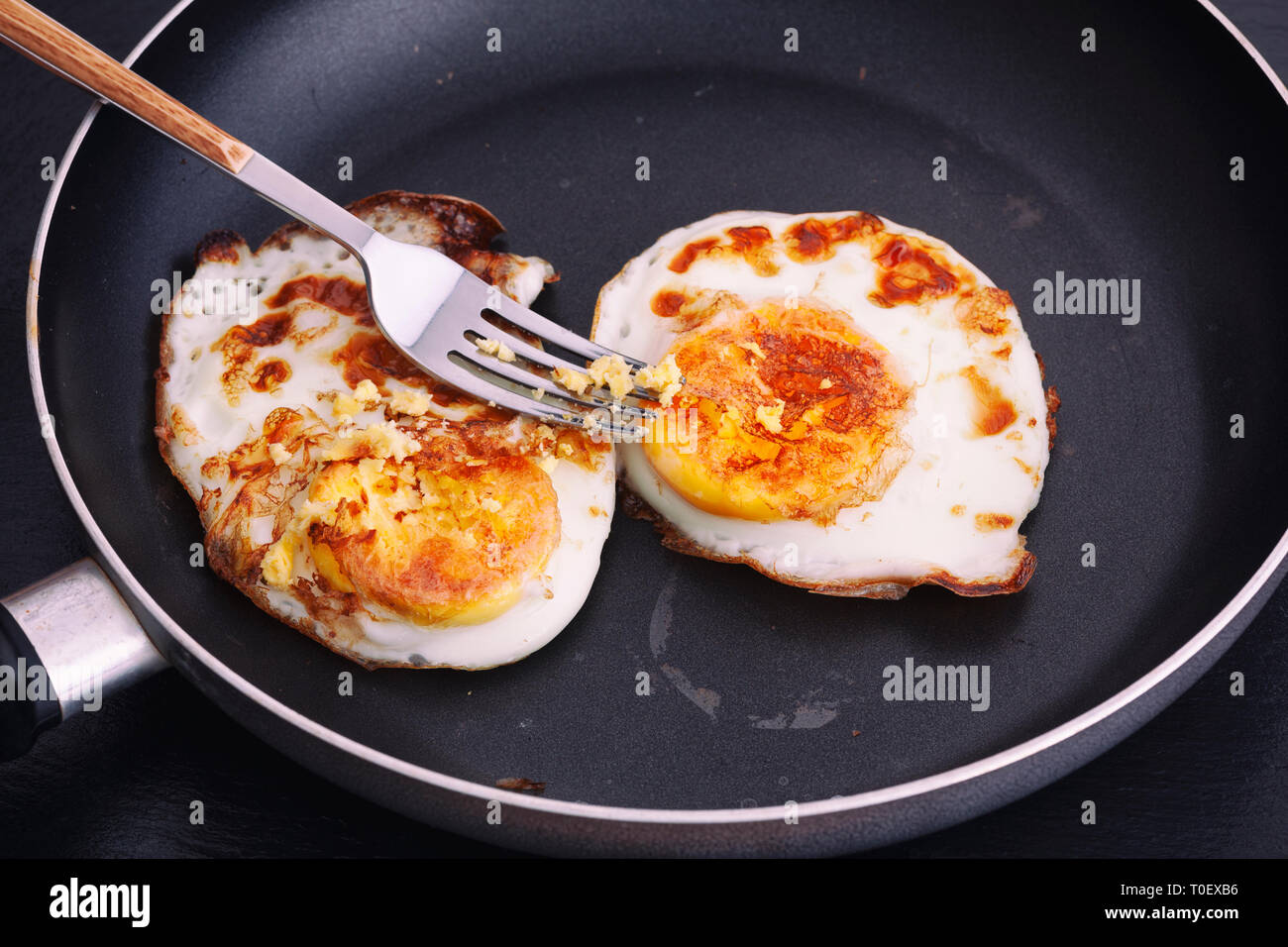Fried eggs in a pan. Natural lighting. Close up. Stock Photo