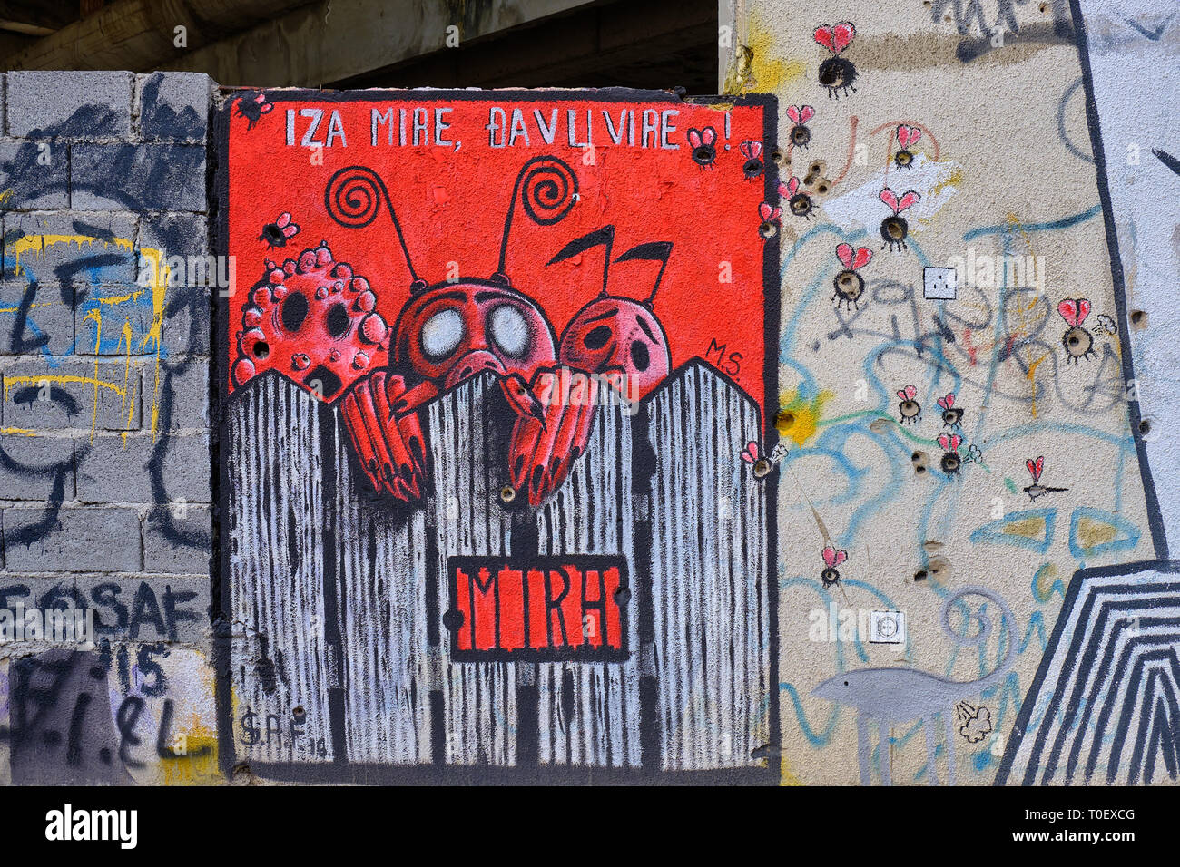 Wall art in Mostar, where the painter used bullet and shrapnel holes as part of design.  Bullet holes used as body of bugs Stock Photo