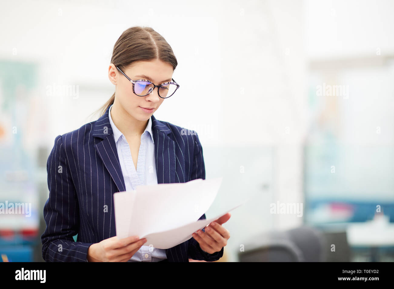 Pretty business woman holding document hi-res stock photography and ...