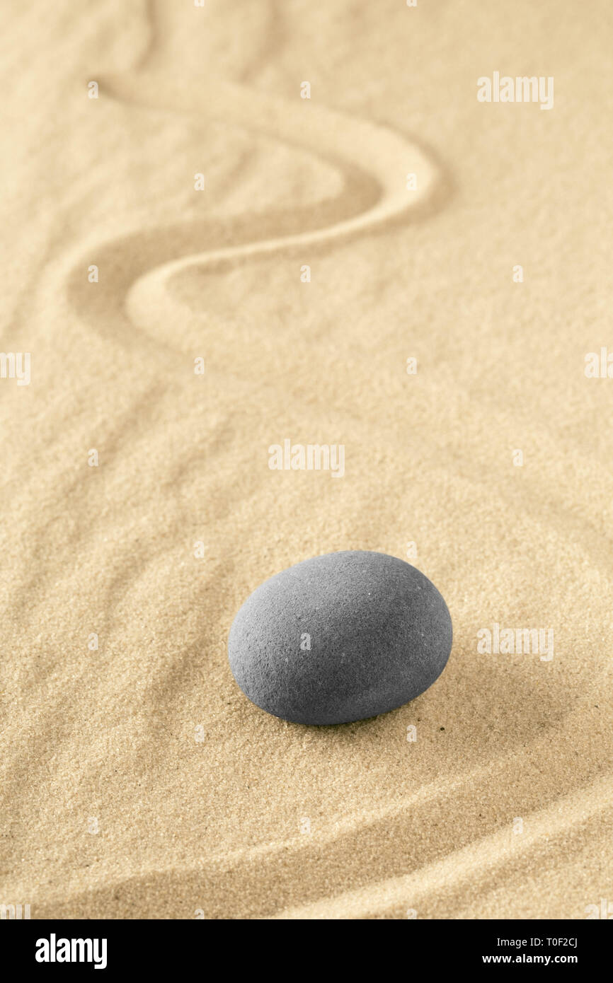 Healing treatment or spiritual therapy trough relaxation and meditation concentrating on a zen stone garden. Spa wellness background with sand texture Stock Photo