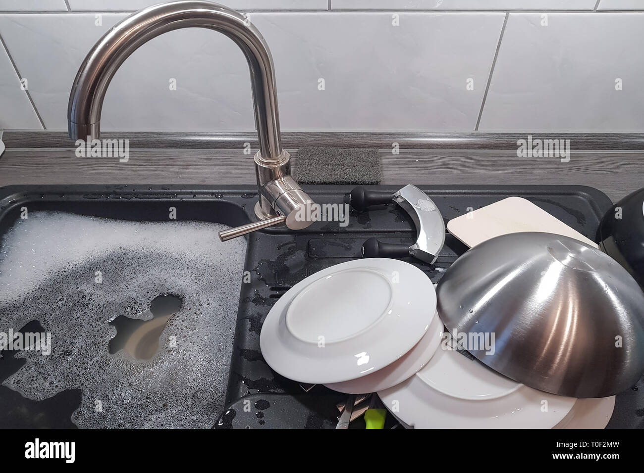 Wash and dry kitchen utensils on the sink by hand Stock Photo Alamy